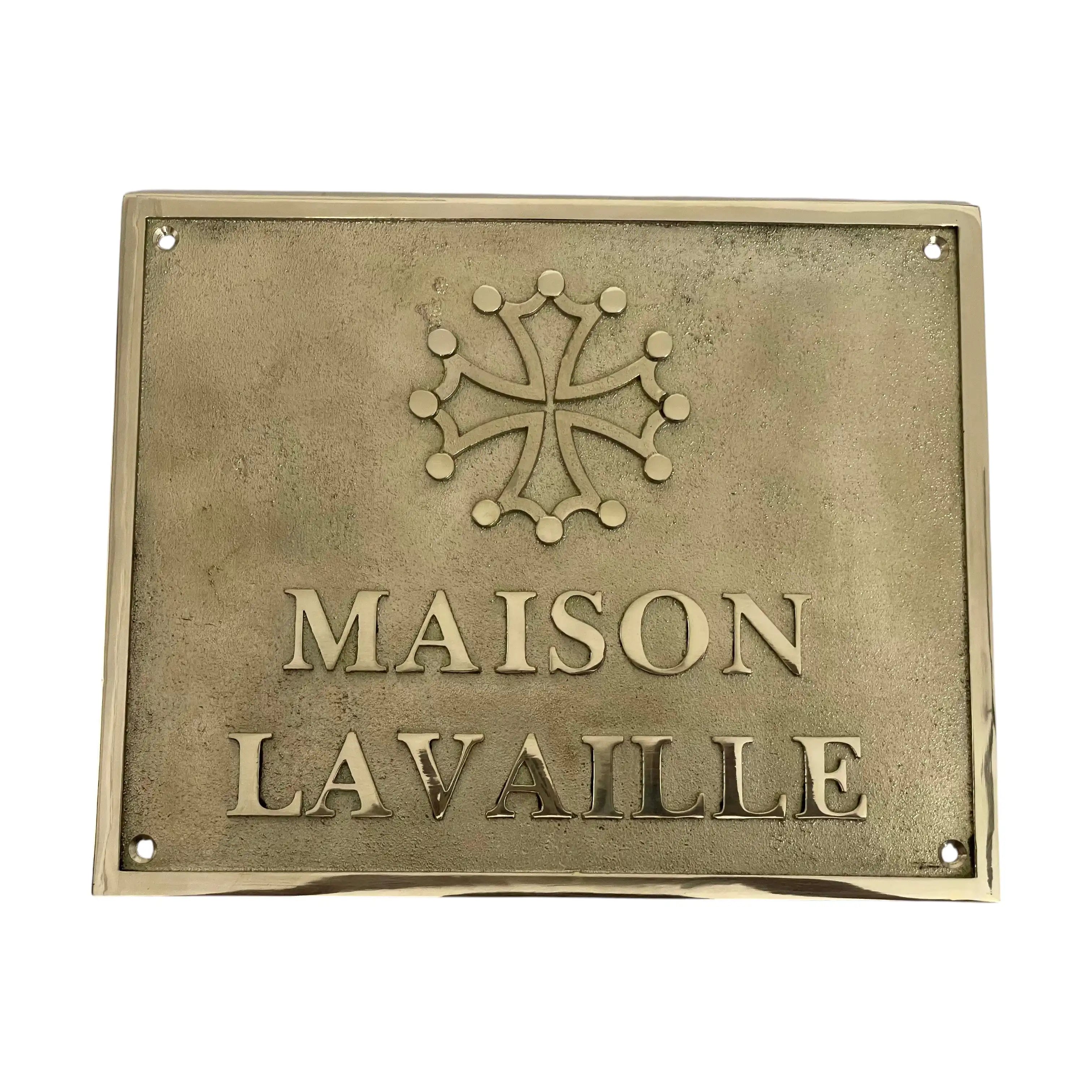 Brass plaque with 'MAISON LAVAILLE' and a decorative emblem on a white background