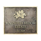 Address sign with 'Magnolia Bloom Estate' and a floral design on a textured background.