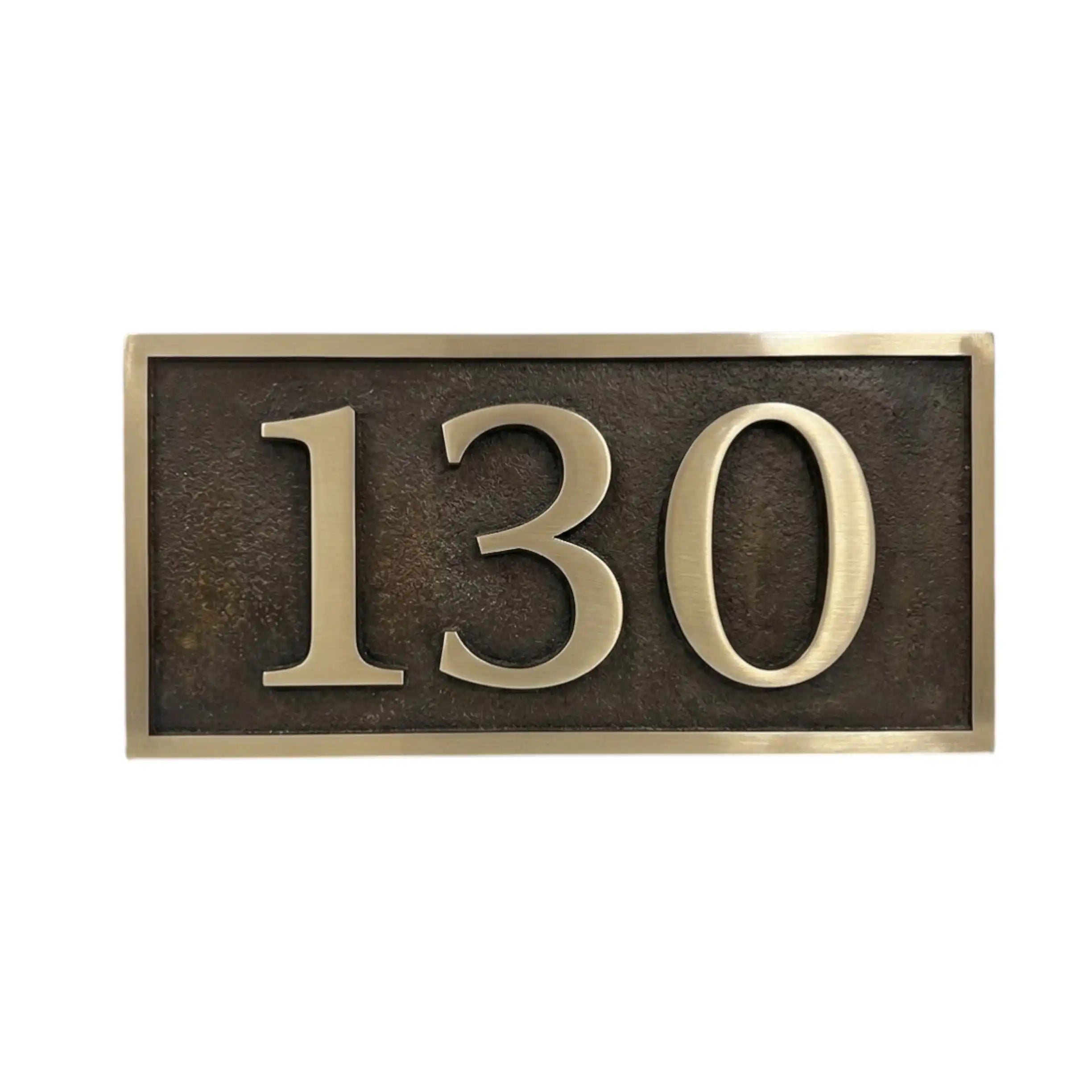 Rectangular house number sign with '130' on a white background
