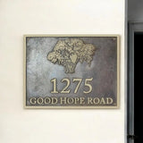 Bronze house number sign with tree design on a metallic background