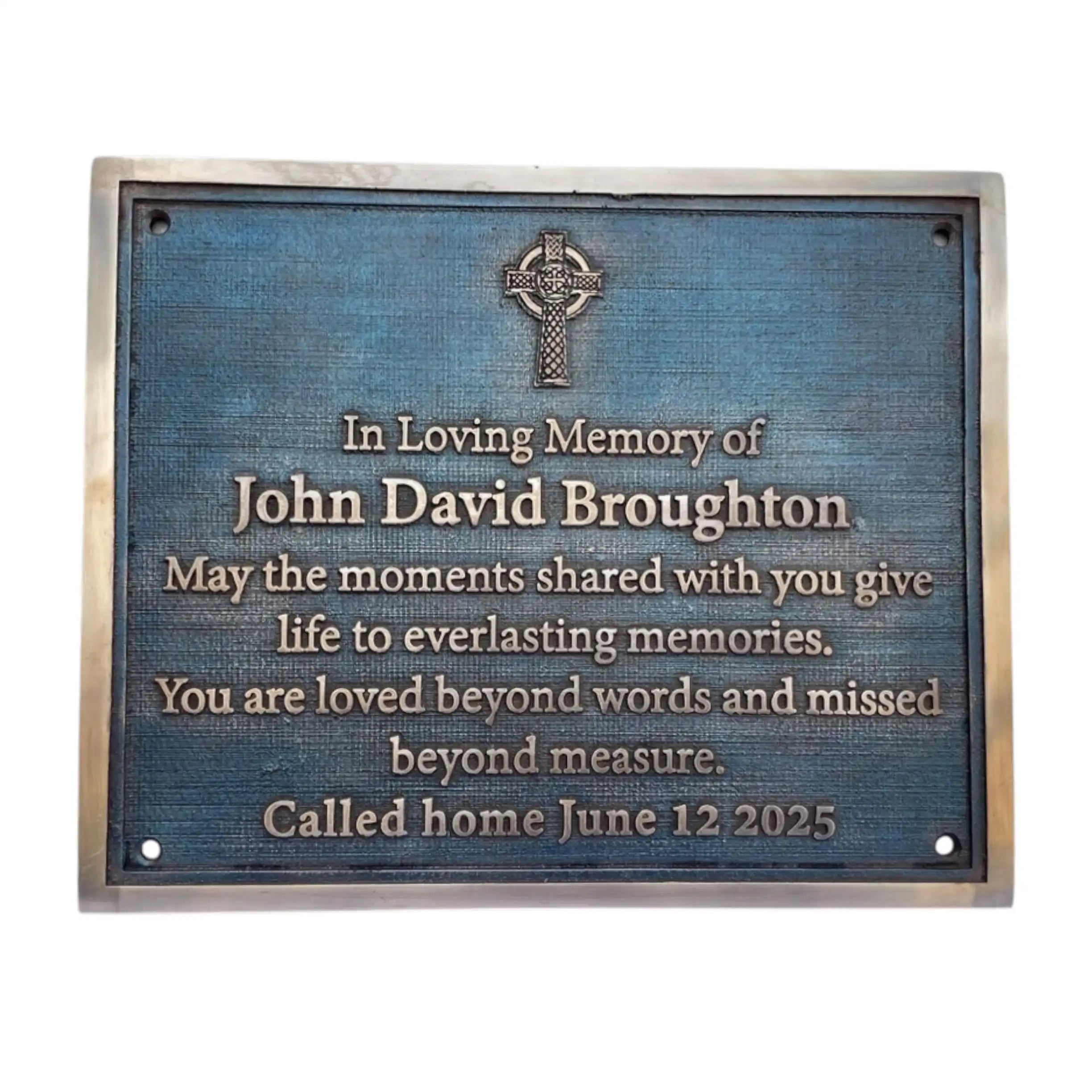 Memorial plaque with Celtic cross design on a blue background