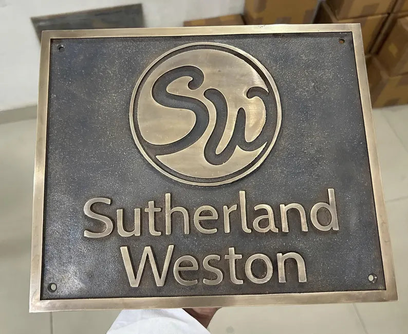bronze plaque with 'Sutherland Weston' branding on a neutral background