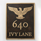 Bronze or brass address plaque featuring a cast eagle emblem above the house number and street name.
