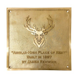 Gold plaque with deer emblem and text on a white background