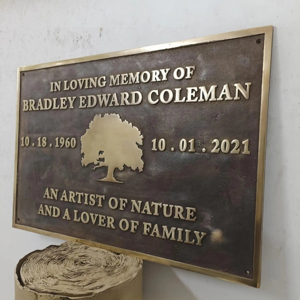 Memorial plaque for Bradley Edward Coleman with tree design and text on a white background