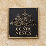 Address sign with 'Costa Nestis' on a textured wall
