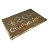 Rustic metal house number sign with '4208 Clinton Ave' on a white background