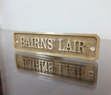 Close up detail of cast brass name plaque engraving