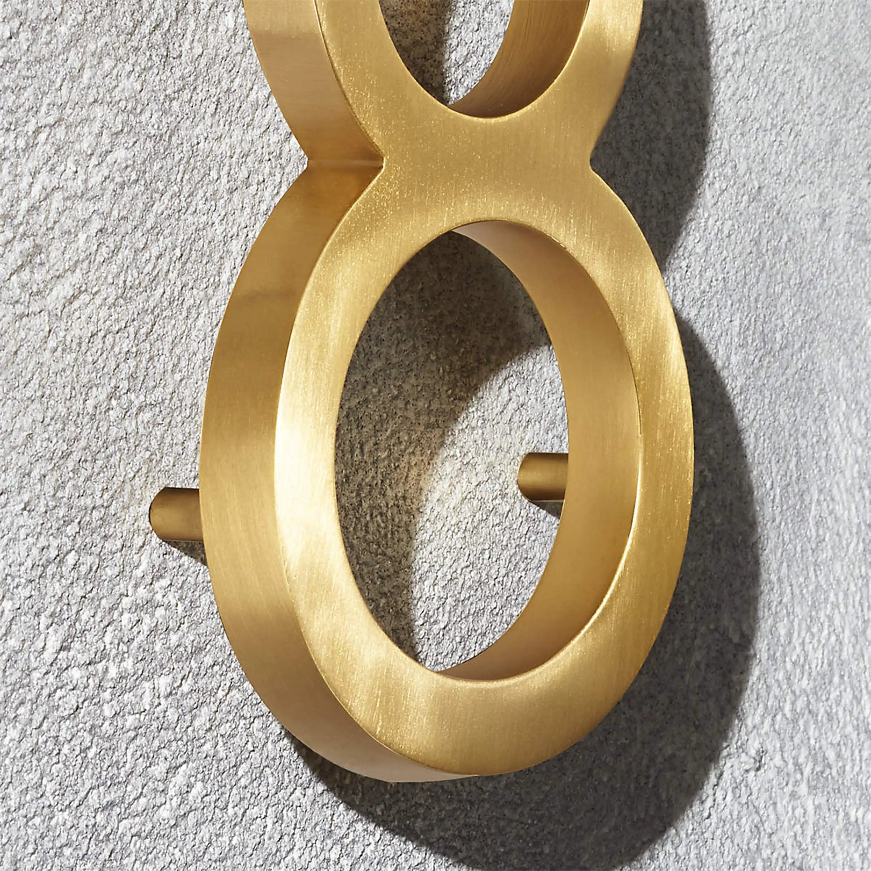 Custom solid brass building address numbers designed with a three-dimensional floating effect and concealed mounting.