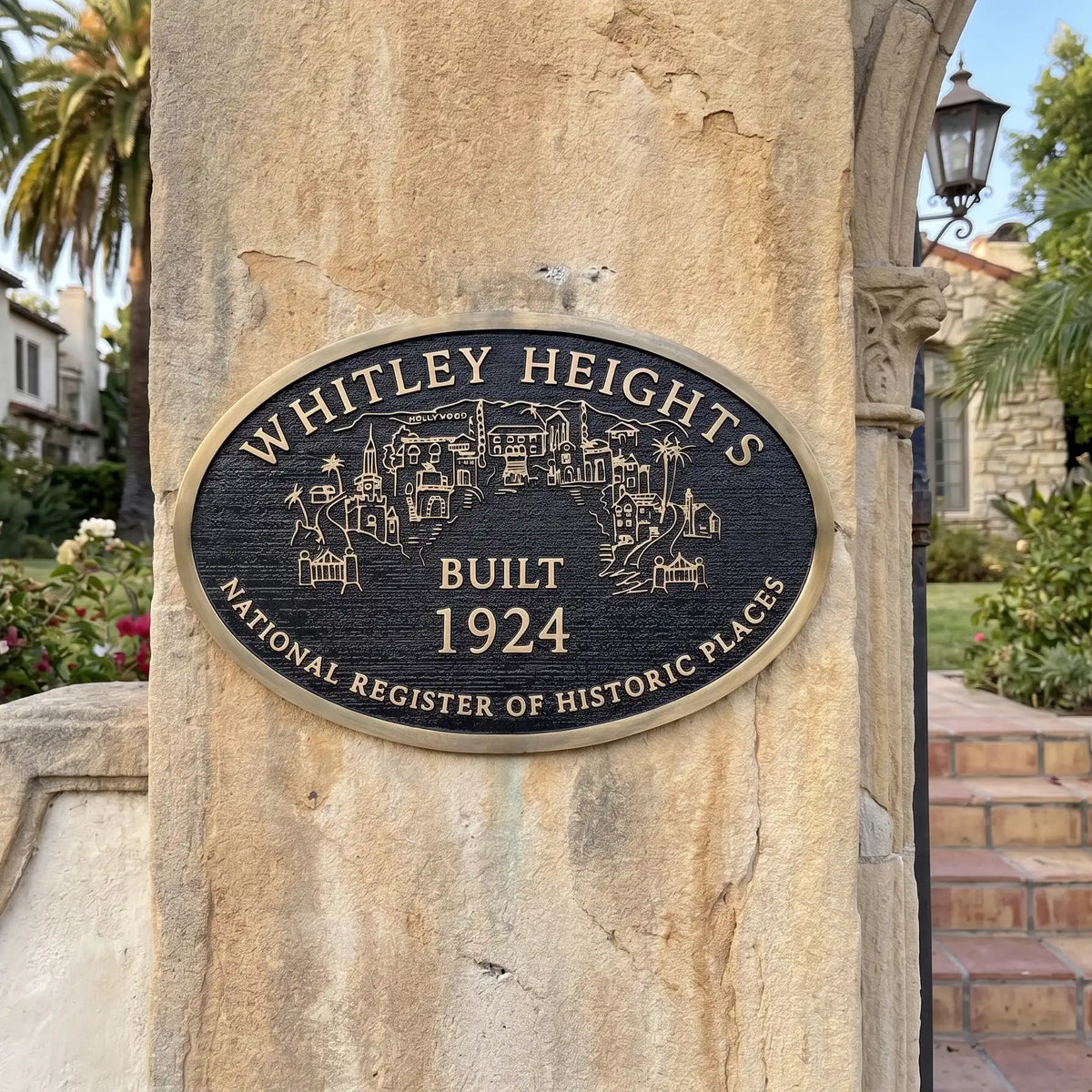 Historical Plaque on a stone column indicating 'Whitley Heights Built 1924' with a scenic illustration.