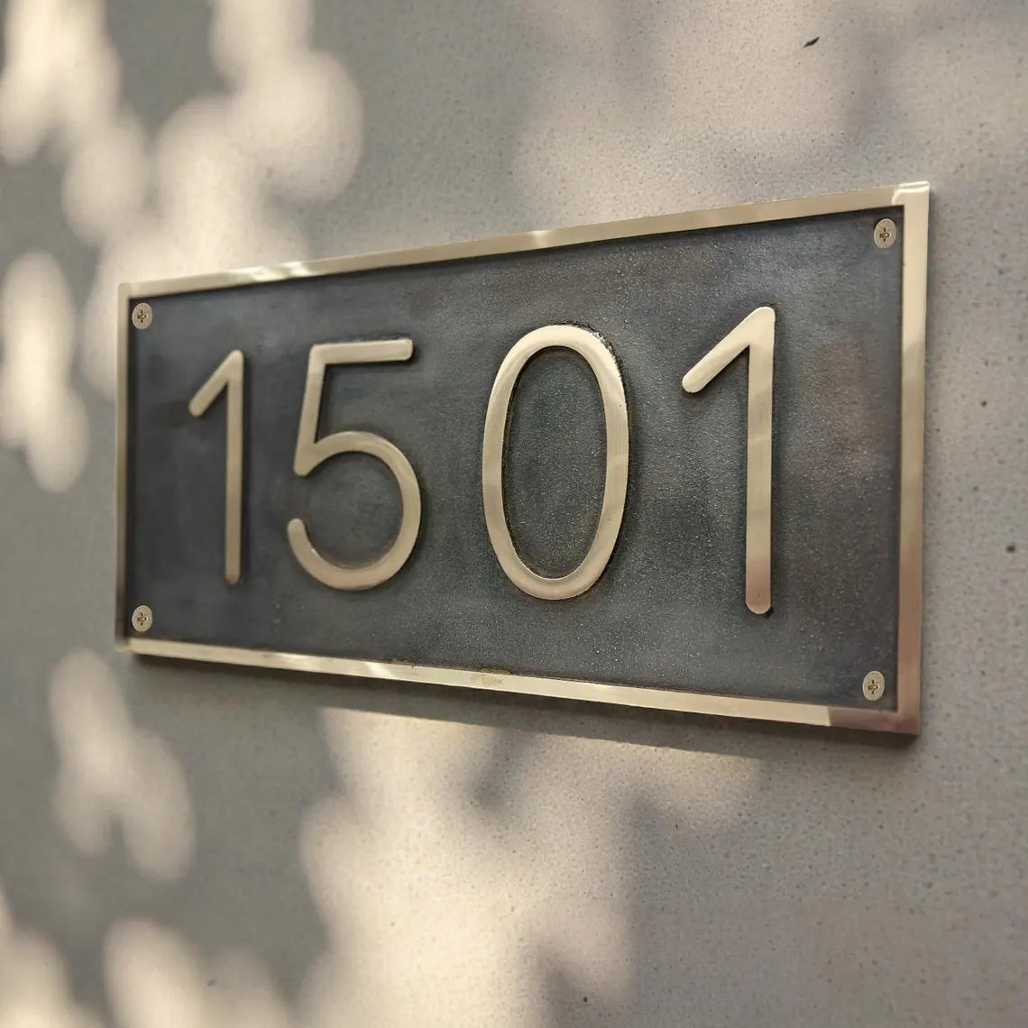 House number plate with '1501' on a textured wall