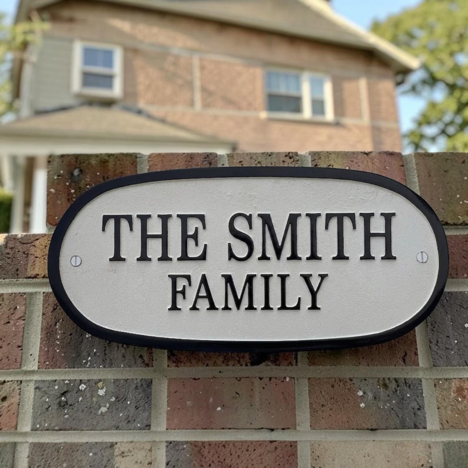 House sign with 'The Smith Family' on a brick wall