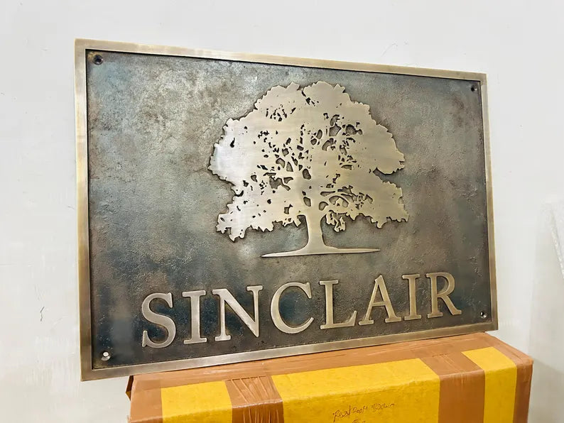 Custom Bronze Plaques -  Address Plaques Metal sign with tree design and 'Sinclair' text on a white background