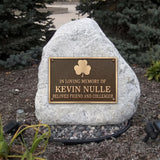 Memorial bronze plaque with a stone honoring Kevin Nulle in a garden setting.