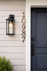 Vertical solid bronze address numbers in an oil rubbed bronze finish mounted on a wall